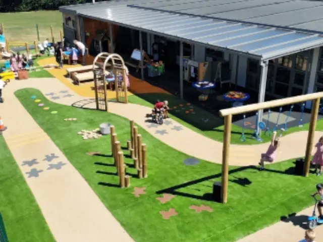 school playground with artificial grass and footpath with trim trail