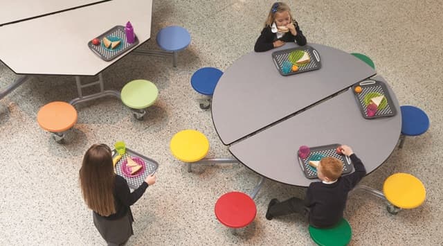 Primary school students eating their lunch around a Spaceright circular canteen table