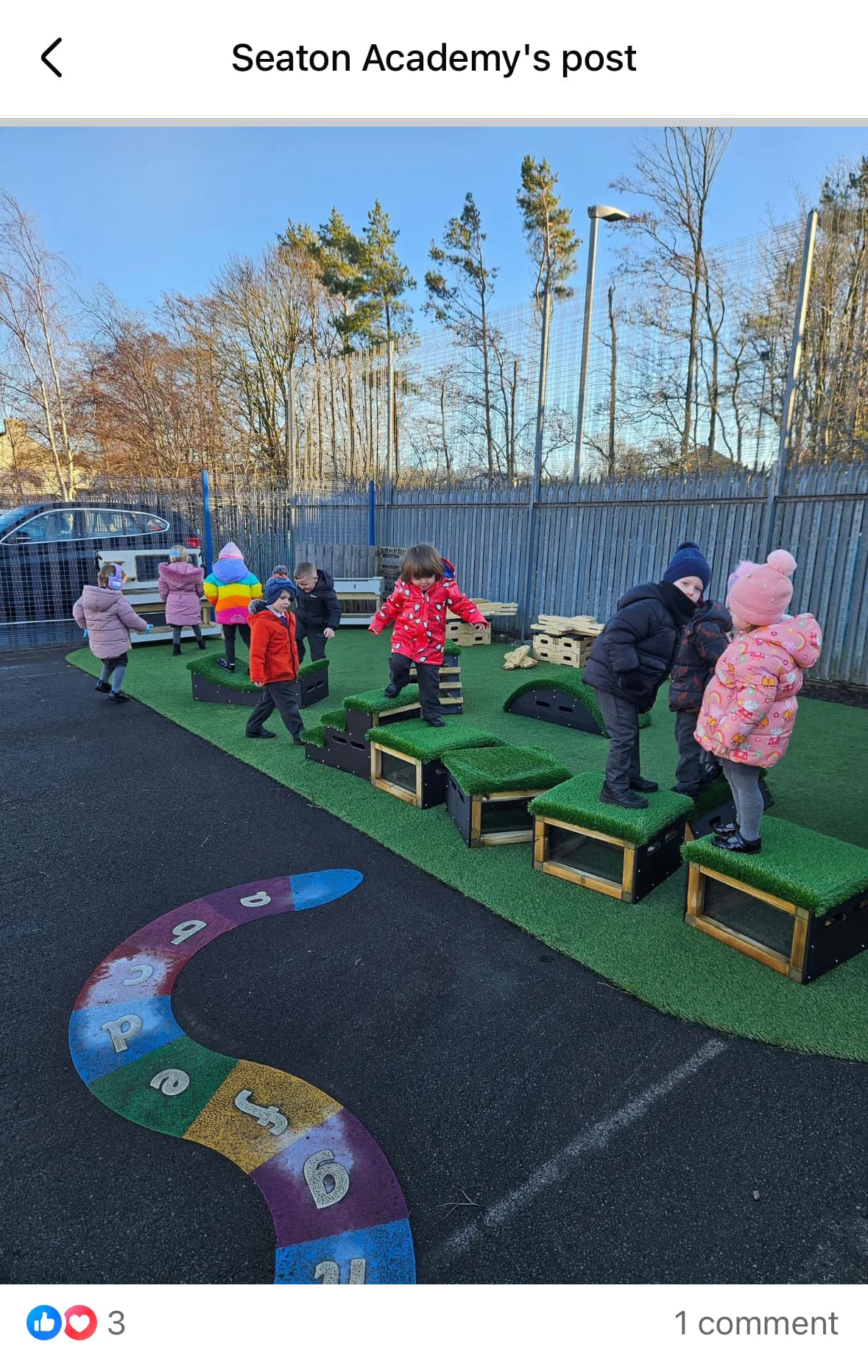 A large group of children are playing on Get Set Go blocks on their playground during the winter.