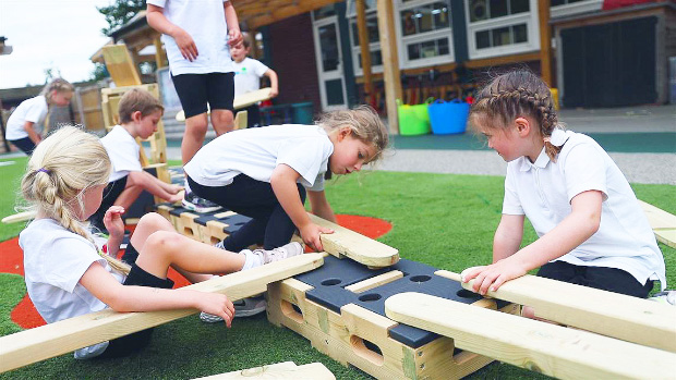 children building together with a play builder set