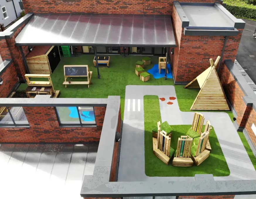 Renovated playground with new equipment and artificial grass